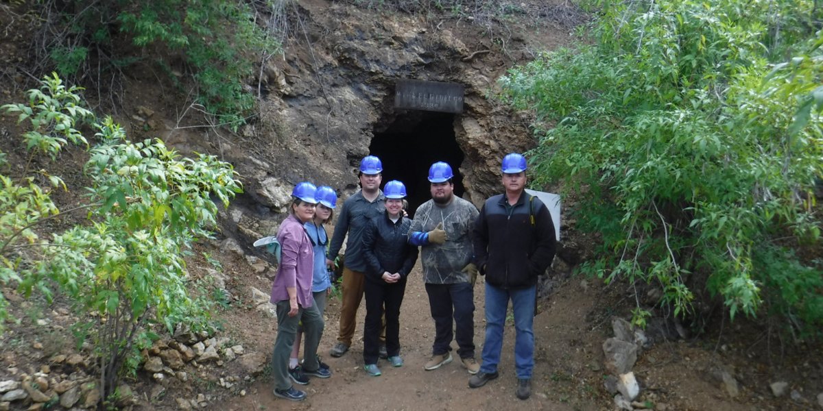 A small group explores the old mining town of El Triunfo