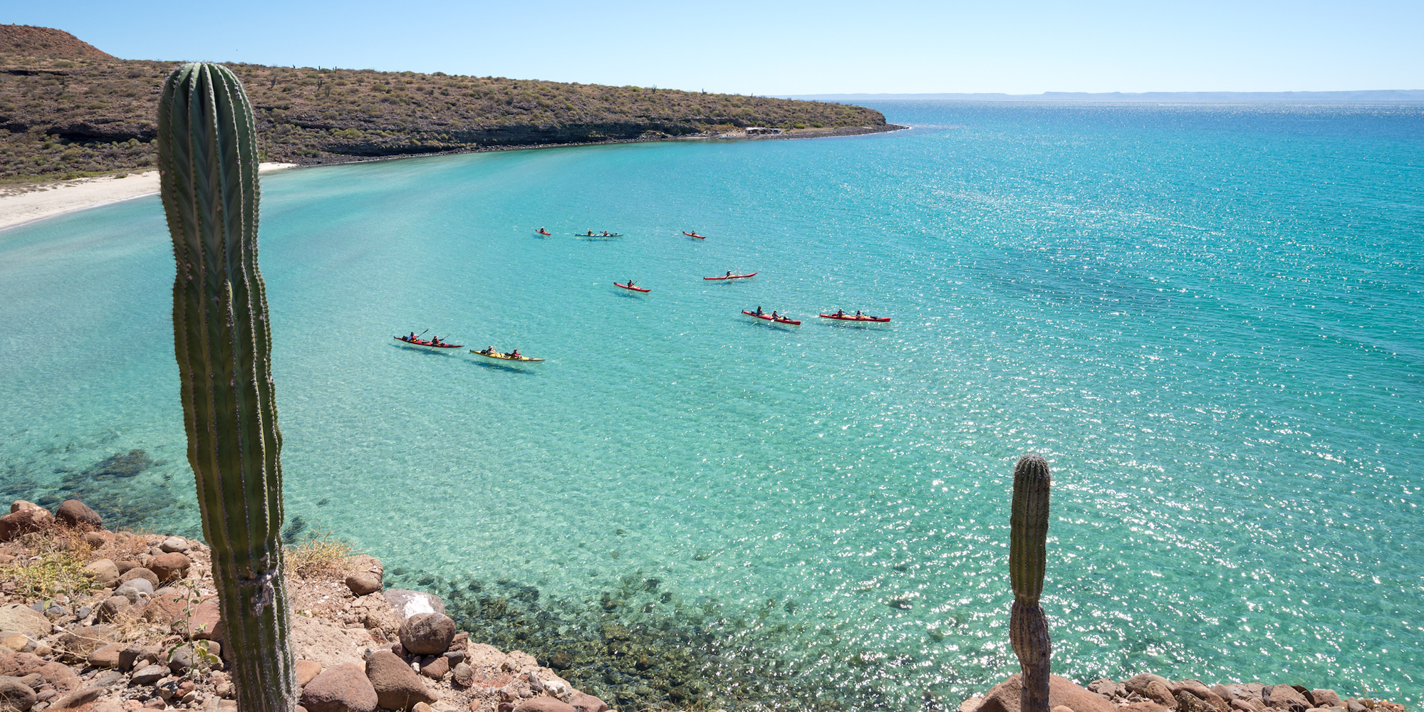 Panoramic view of sea kayakers and cacti on the Sea of Cortez