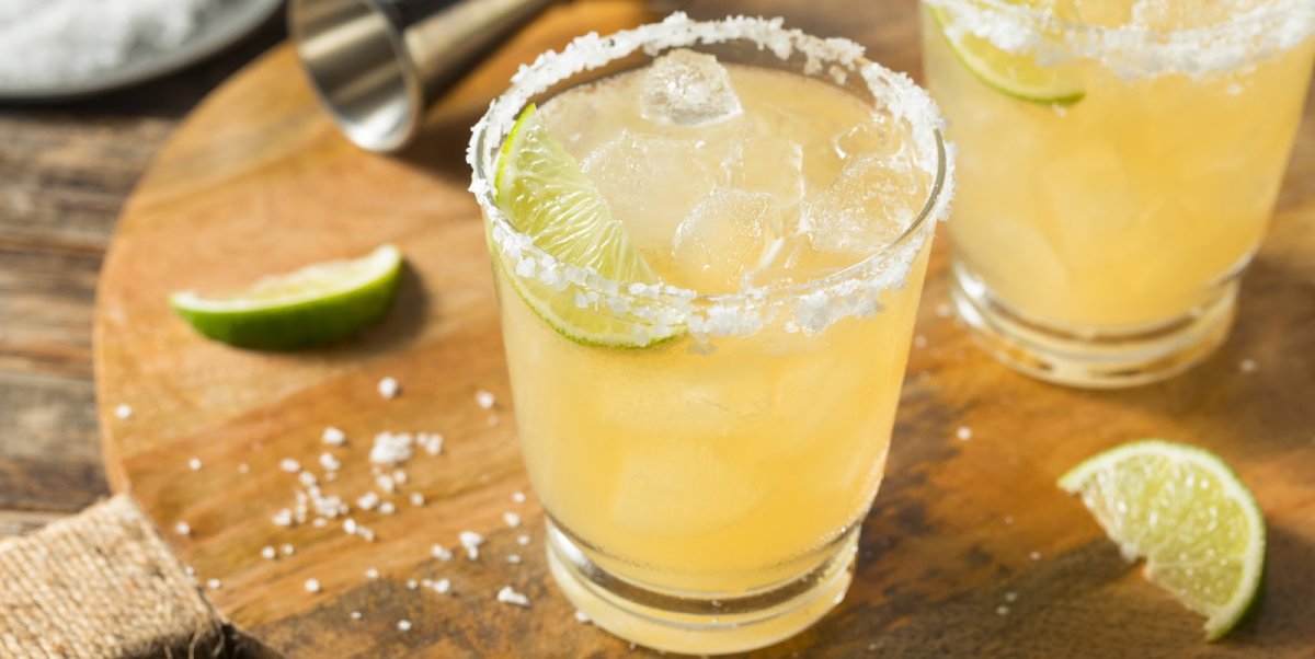 Margaritas with salt and lime on a wooden table