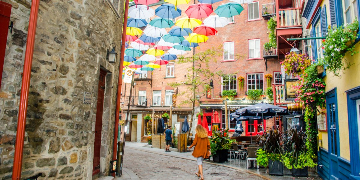 A girl walking down an old Quebec city street in Quebec City