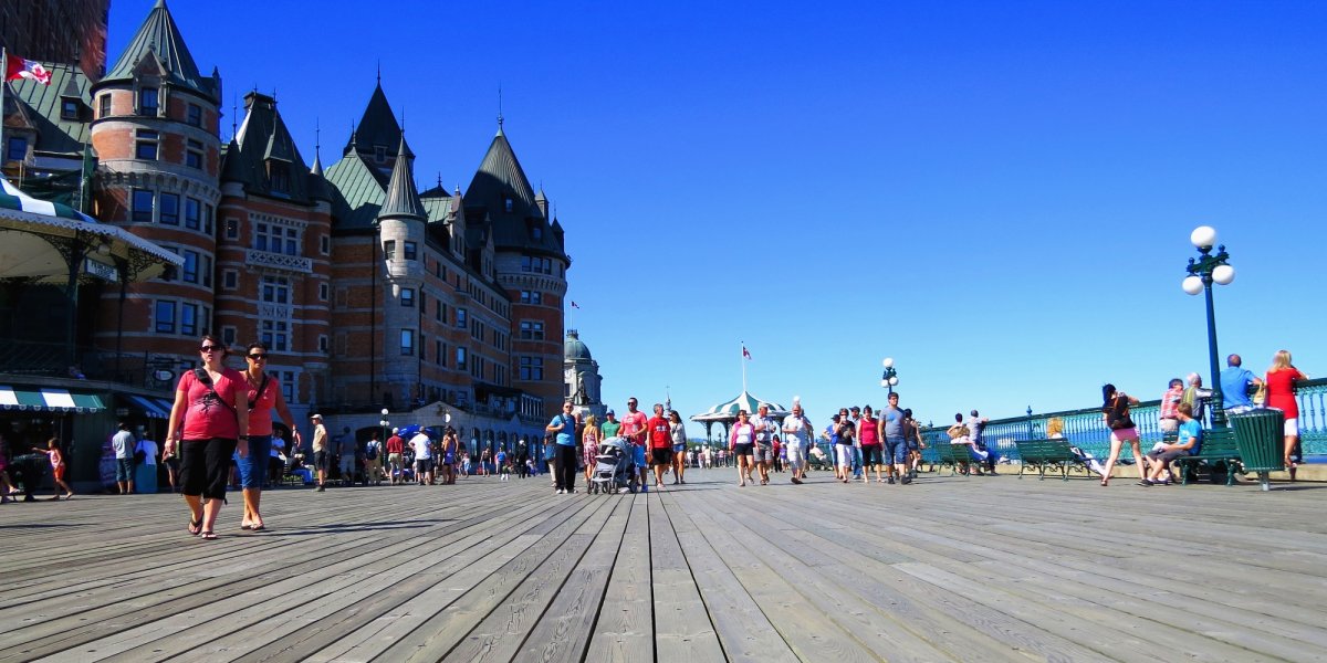 Tourists and locals walk along the Dufferin Terrace in Old Quebec City