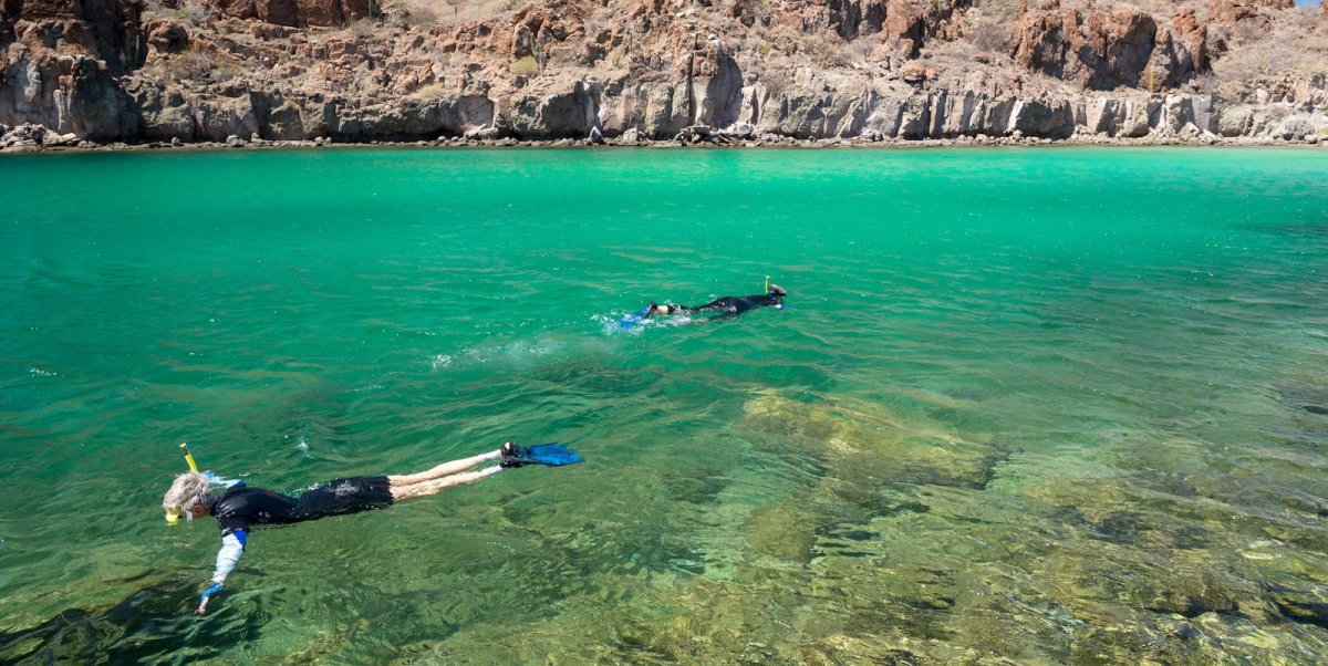 Two tourists snorkeling in the Sea of Cortez in Loreto, Baja