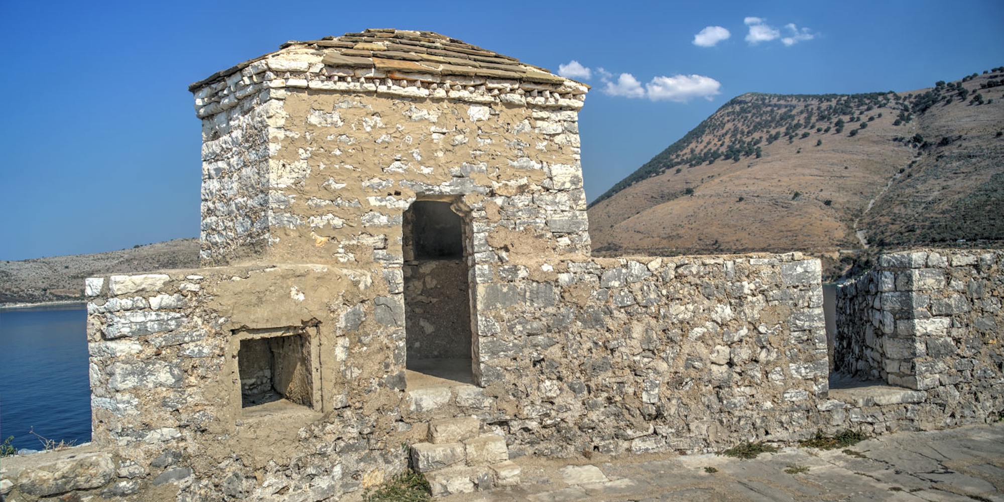 Local guide shares the history of an ancient archaeological site with guests exploring Albania on a multi country tour.
