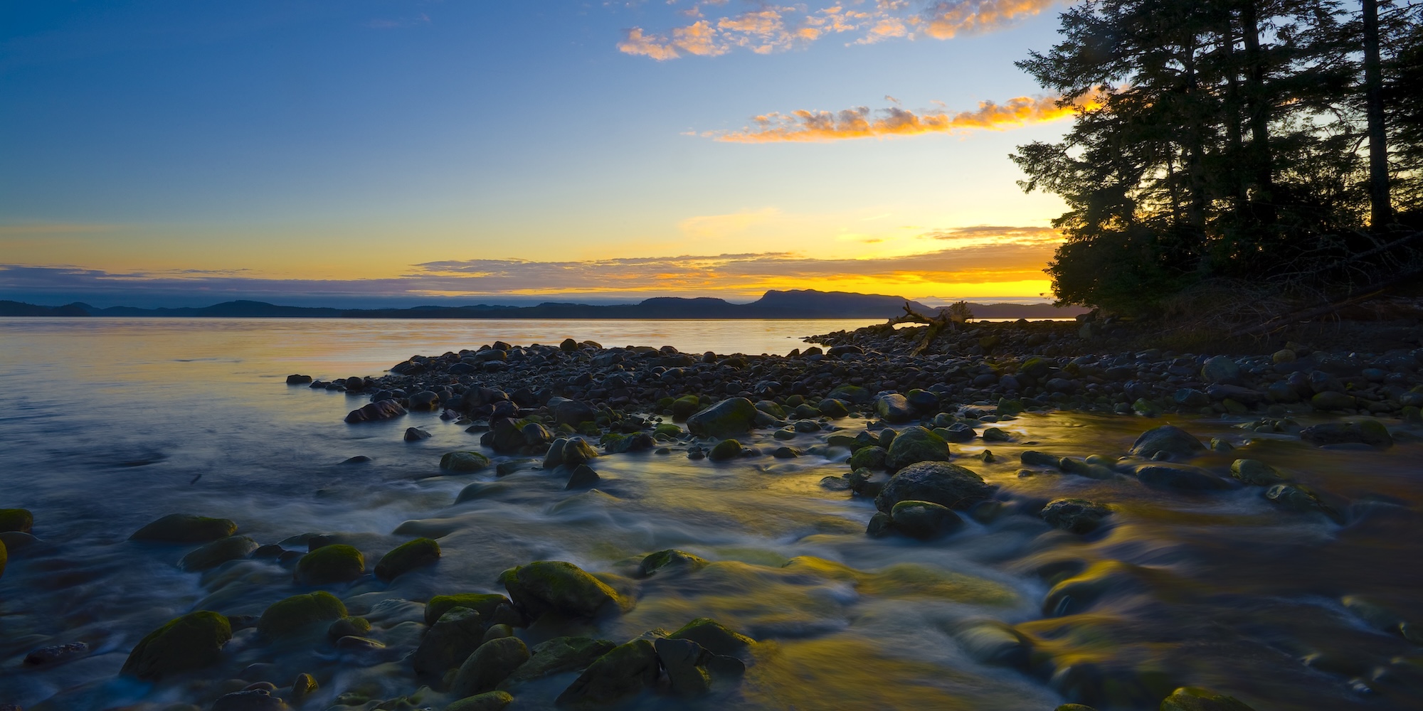 Rocky shoreline along the north coast of Vancouver Island at sunset near Port McNeill