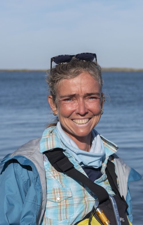 Sea Kayak Adventures guide, Jennifer, smiling for a photo in front of the Gulf of California. 