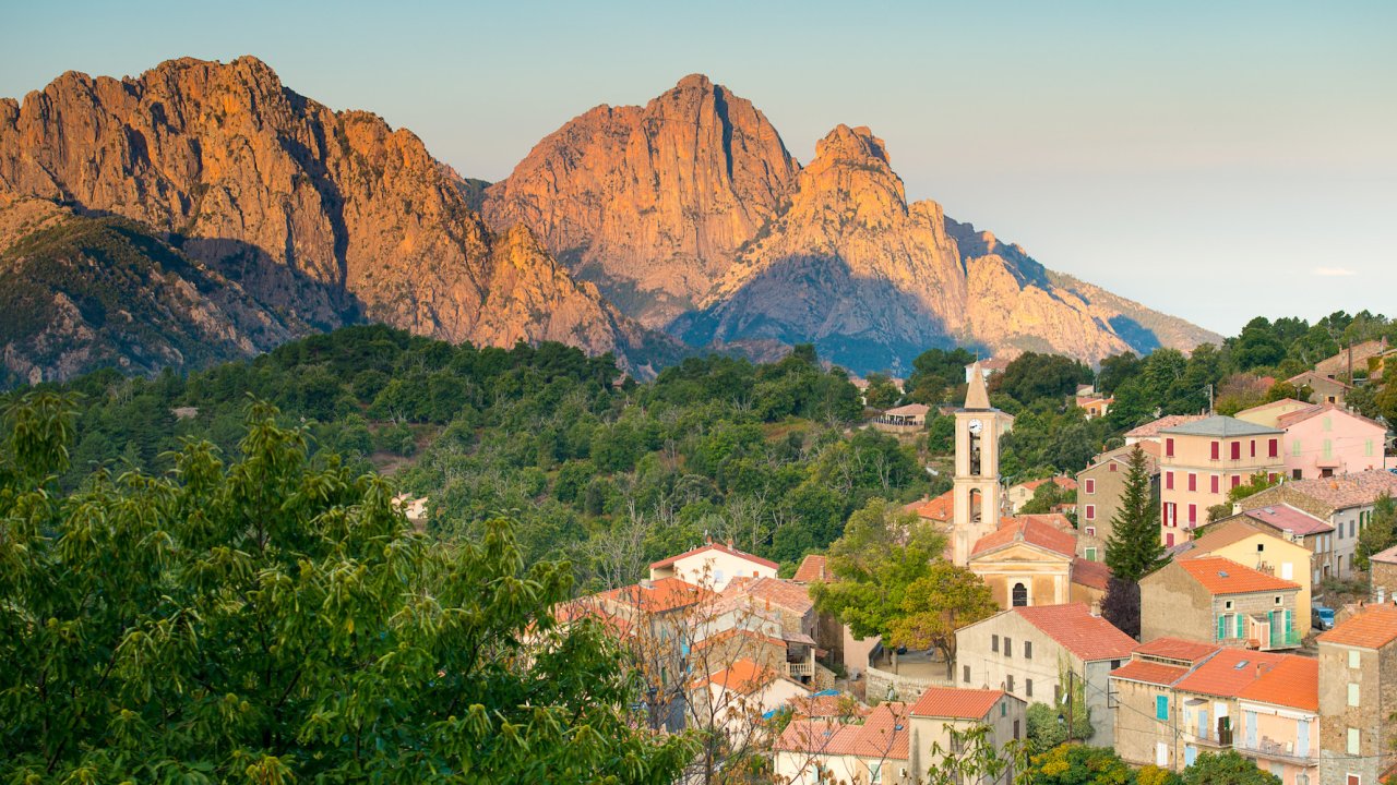 View of maquis, homes, and limestone cliffs in Corsica, France