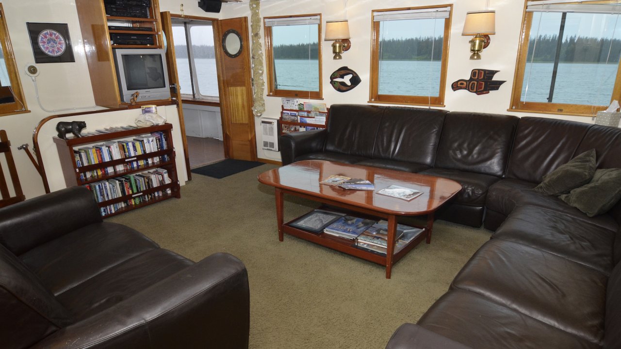 Communal salon with black leather couches aboard the Sea Wolf Boat 