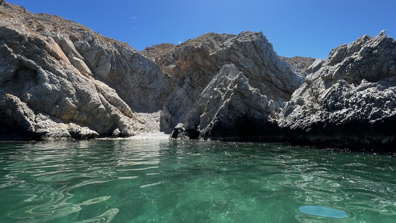 Desert rock formations jetting out of the turquoise waters of the Sea of Cortez in Baja California Sur
