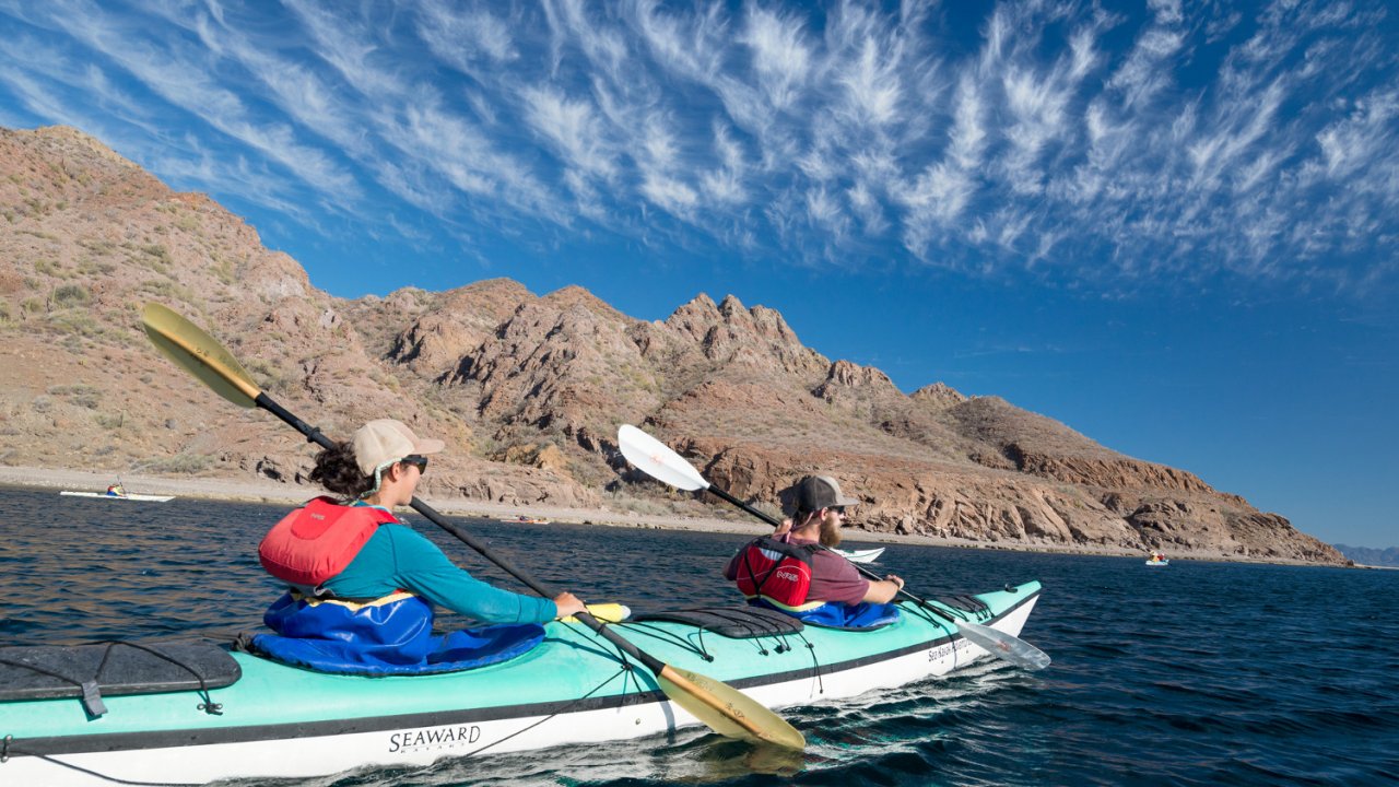 woman paddling sea kayak in Baja