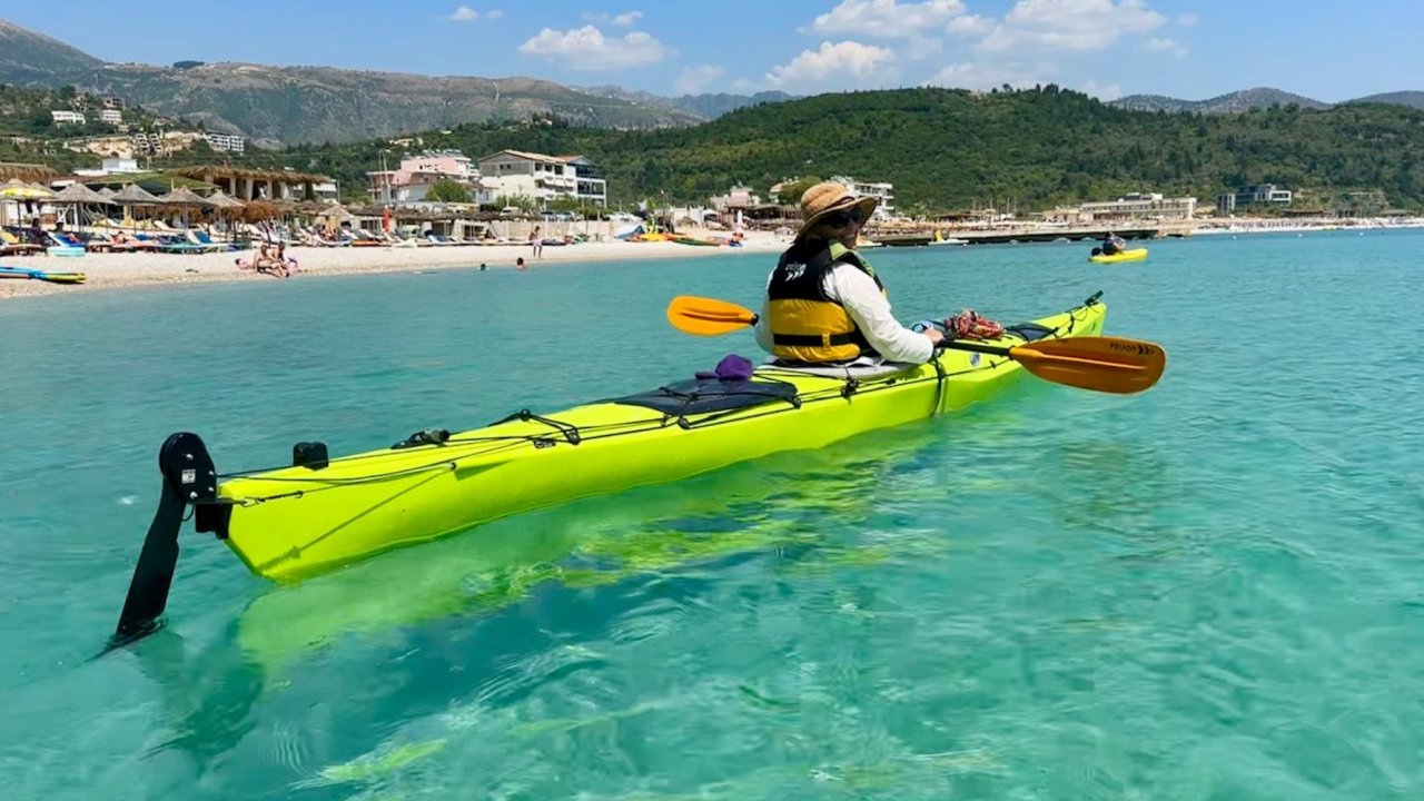A woman in a sea kayak in the clear waters off of Croatia.