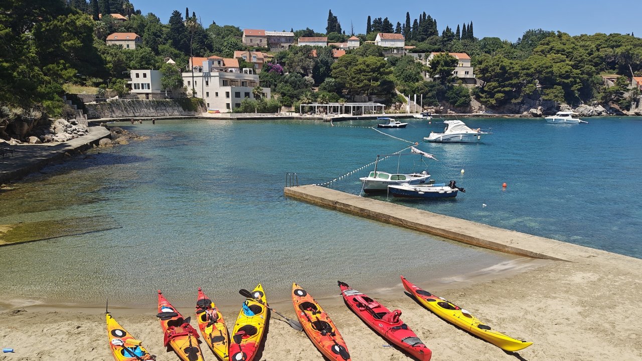 A line of kayaks on shore in Croatia