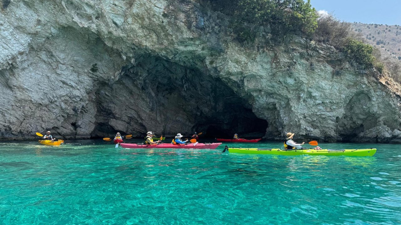 A group of sea kayakers paddling the turquoise waters of the Adriatic Sea