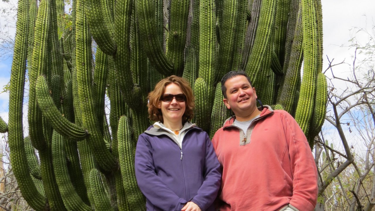 couple in front of large cactus in Baja