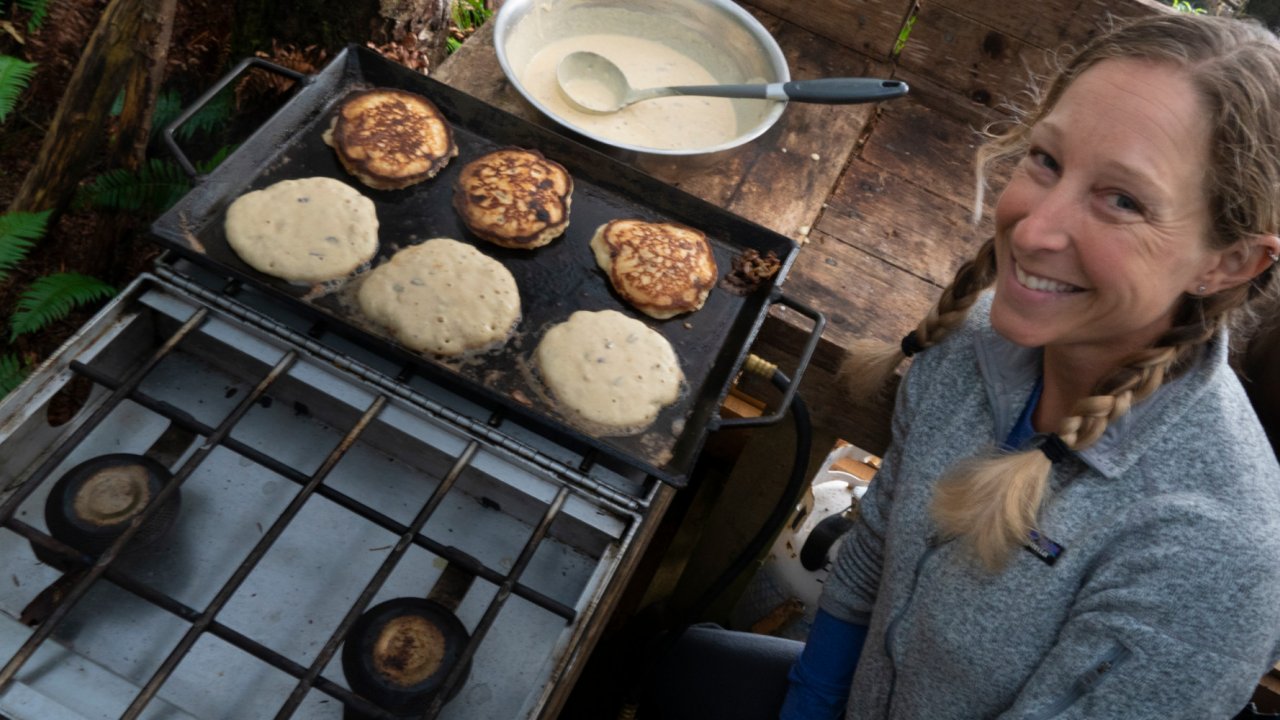 female making pancakes on outdoor griddle