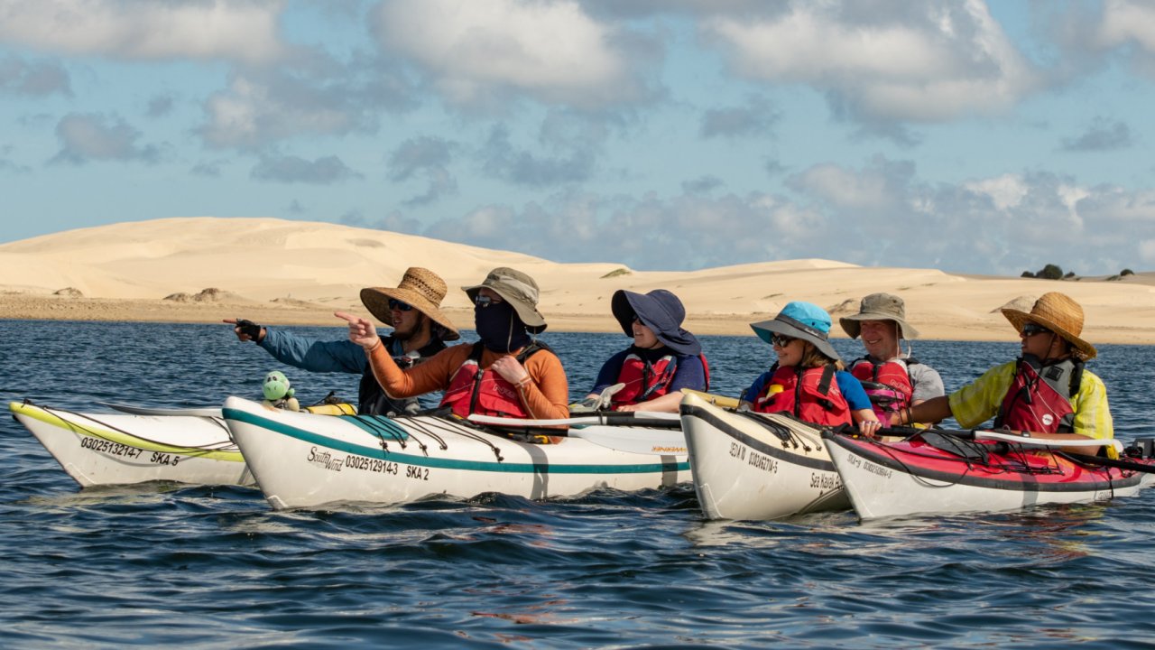 group of kayak paddlers resting together