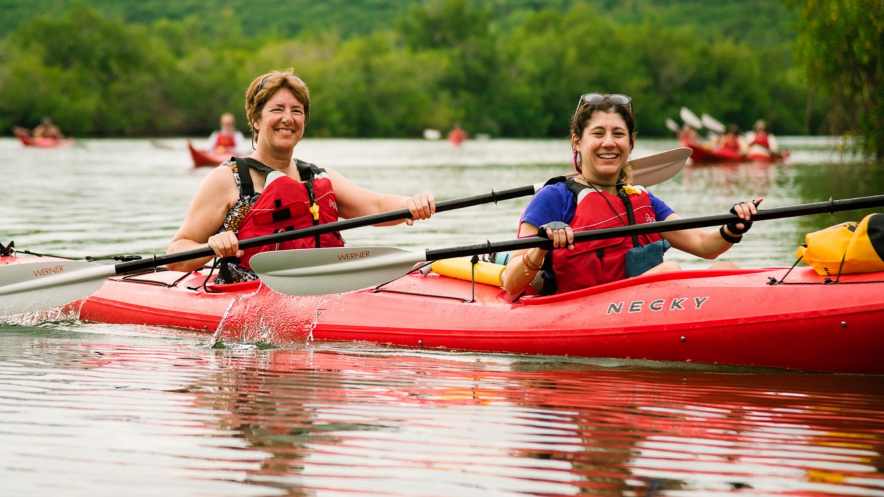 women paddling sea kayak in cuba