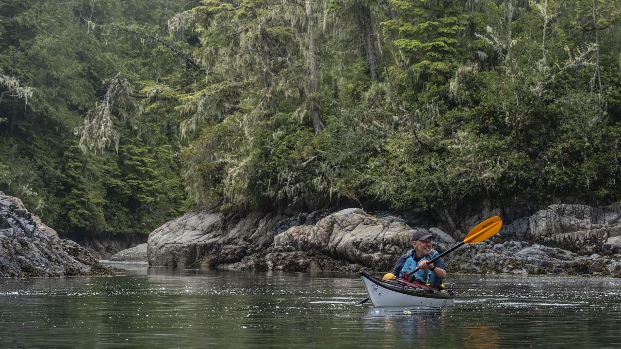 Sea kayaker paddling through calm waters near Blackfish Sound on Vancouver Island