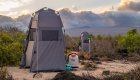 A stand up tent holding a portable compostable toilet at an eco beach camp in the Galapagos Islands