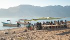 A group of campers on a beach in Loreto Bay under a sun shade