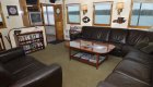 Communal salon with black leather couches aboard the Sea Wolf Boat 