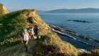 Hikers along a scenic coastal trail above the Adriatic Sea in Albania.