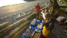 Guides making dinner while camping on a rocky beach in British Columbia