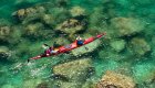 Birds eye view of a red kayak paddling through the clear waters of the Sea of Cortez
