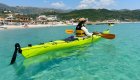 A woman in a sea kayak in the clear waters off of Croatia.