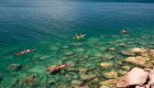 Scenic view of sea kayakers atop crystal clear water in the Sea of Cortez off of Isla Espiritu Santo