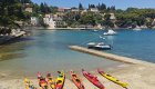 A line of kayaks on shore in Croatia
