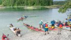sea kayaks and people on wilderness beach in British Columbia