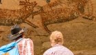 men looking at prehistoric rock art in Baja California Sur
