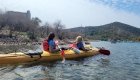 Two travelers kayaking along Turkey’s scenic coastline during a guided sea kayaking tour in Europe.