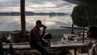 man sitting on log along vancouver island shore