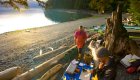 sea kayak guide cooking breakfast on ocean beach