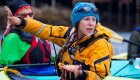 female kayak guide holding sea start while pointing