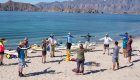 kayaking group stretching on beach