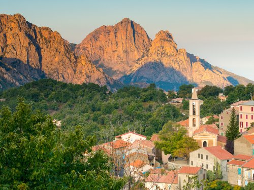 View of maquis, homes, and limestone cliffs in Corsica, France