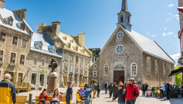 Tourists walk through Place-Royale in Old Quebec City