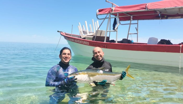 Sea Kayak Adventures guides holding a fish in the Sea of Cortez