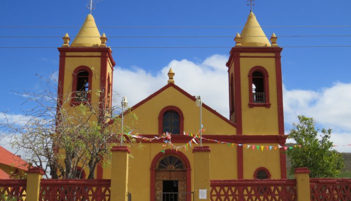 yellow and red church in old mining town in baja